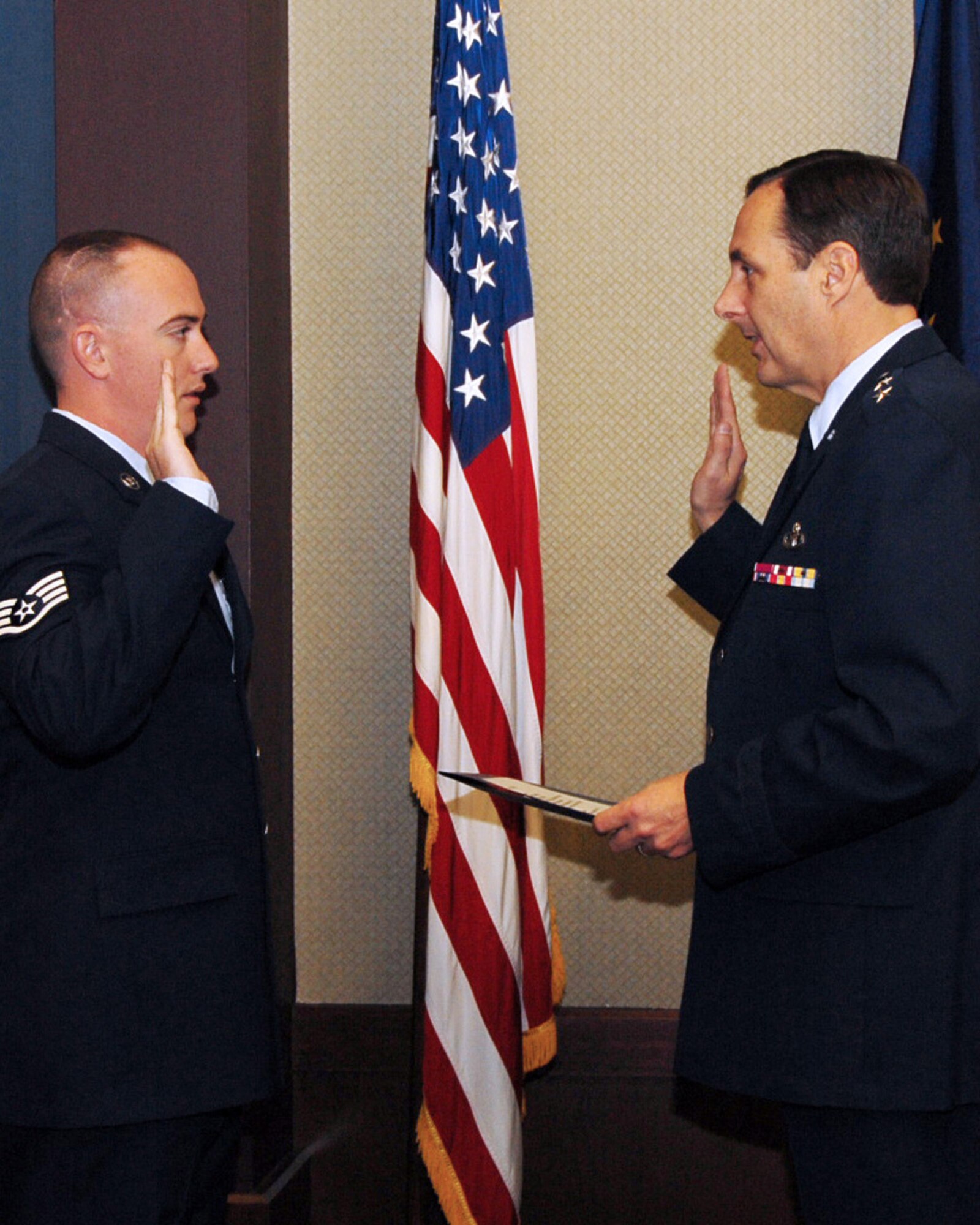 Staff Sgt. Richard Rauckhorst, formerly of the 314th Aircraft Maintenance Squadron, is enlisted March 4 into the Alaska Air National Guard by Maj. Gen. Craig Campbell, Alaska’s adjutant general. The general is the staff sergeant’s father-in-law, and he flew to Arkansas for the ceremony. Sergeant Rauckhorst is now assigned to the 176th Air Control Squadron at Elmendorf Air Force Base, Alaska. (U.S. Air Force photo by Master Sgt. Dianna Seerey)