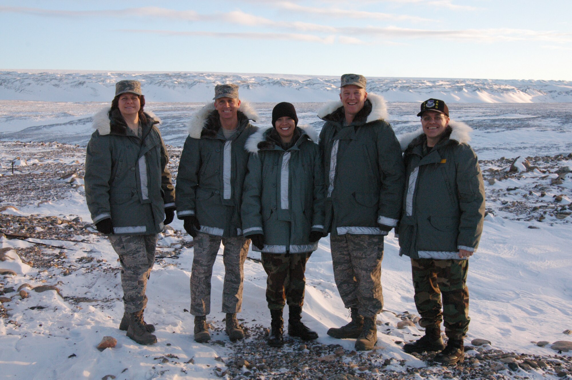 THULE AIR BASE, Greenland -- Col. John Raymond, 21st Space Wing commander, and Chief Master Sgt. Timothy Omdal, 21st SW command chief, along with Staff Sgt. Ava Dunn, 21st SW, visited Thule Air Base Feb. 28-29. In addition to visiting Airmen in their work centers at many sites on base, Colonel Raymond hosted a Commander's Call to discuss important topics with the Airmen at Thule. Thule Air Base is considered a globally-separated unit, and its parent wing is the 21st Space Wing located at Peterson Air Force Base, Colo. Pictured from left to right are: Chief Master Sgt. Nathalie Swisher, 821st Air Base Group superintendent, Chief Omdal, Sergeant Dunn, Colonel Raymond, and Col. Lee-Volker Cox, 821st ABG commander. (U.S. Air Force photo/2nd Lt. Donald Heaton)