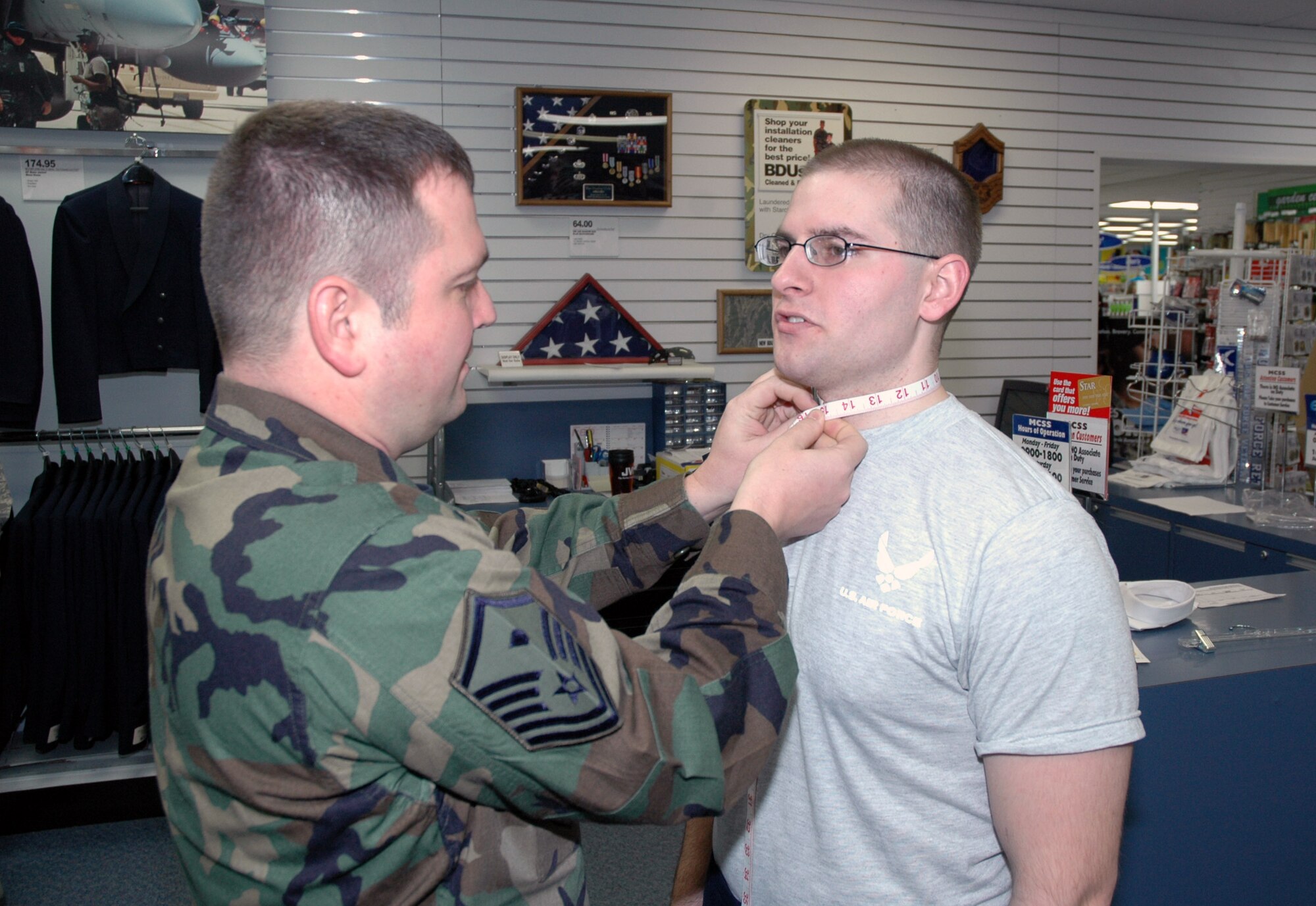 Master Sgt. Nickie Maggard, 341st Operations Group first sergeant, measures Airman 1st Class Jared Bobic, 10th Missile Squadron missile chef and 2007 341st Space Wing Airman of the Year, to determine the proper collar size for his new mess dress paid for by the Big Sky First Sergeant's Council. (U.S. Air Force photo/Airman 1st Class Dillon White)