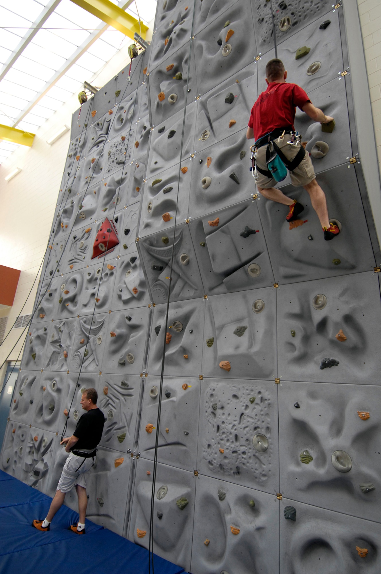 HANSCOM AFB, Mass. -- Climbing instructors demonstrate proper climbing and belaying techniques during a class Feb. 27 offered at the Fitness and Sports Center. Currently, rock climbing classes are offered on Wednesday from 5 to 7 p.m. and on Saturday the center offers family hours from 8 to 10 a.m., in addition to a regular afternoon climbing class from noon to 2 p.m. (U.S. Air Force photo by Mark Wyatt)
