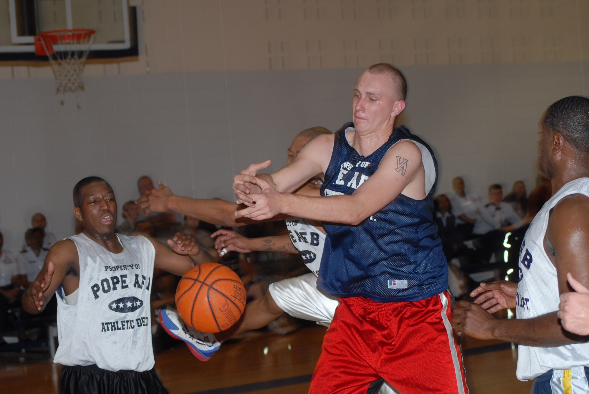 Steven Morris, 43rd Mission Support Squadron, has the ball stripped after grabbing a rebound by Kenneth Carter, 43rd Logistics Readiness Squadron, during the championship game March 3. (U.S. Air Force Photo by 2nd Lt. Chris Hoyler)