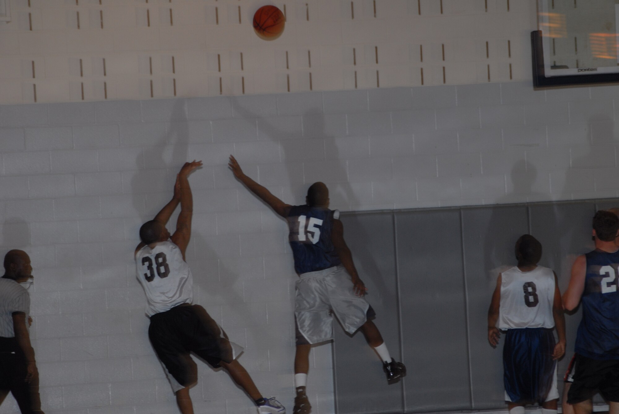 Robert Naylor, 43rd Logistics Readiness Squadron, attempts a fall-away jump shot over Irvin Gourdine, 43rd Mission Support Squadron, during the championship game March 3. (U.S. Air Force Photo by 2nd Lt. Chris Hoyler)