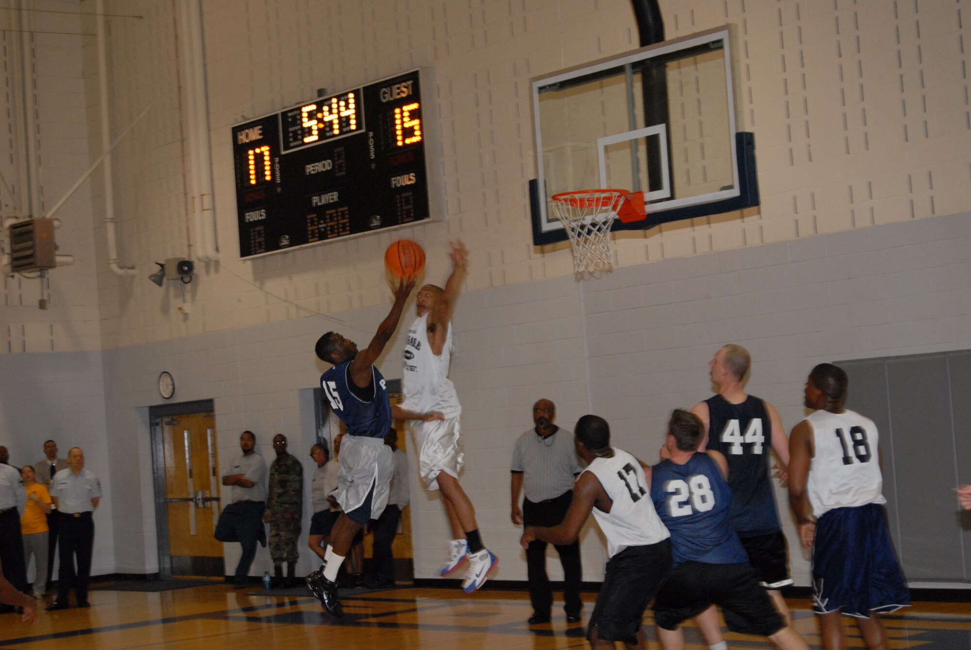 Irvin Gourdine, 43rd Mission Support Squadron, goes for a layup over Kenneth Carter, 43rd Logistics Readiness Squadron, during the championship game March 3. (U.S. Air Force Photo by 2nd Lt. Chris Hoyler)
