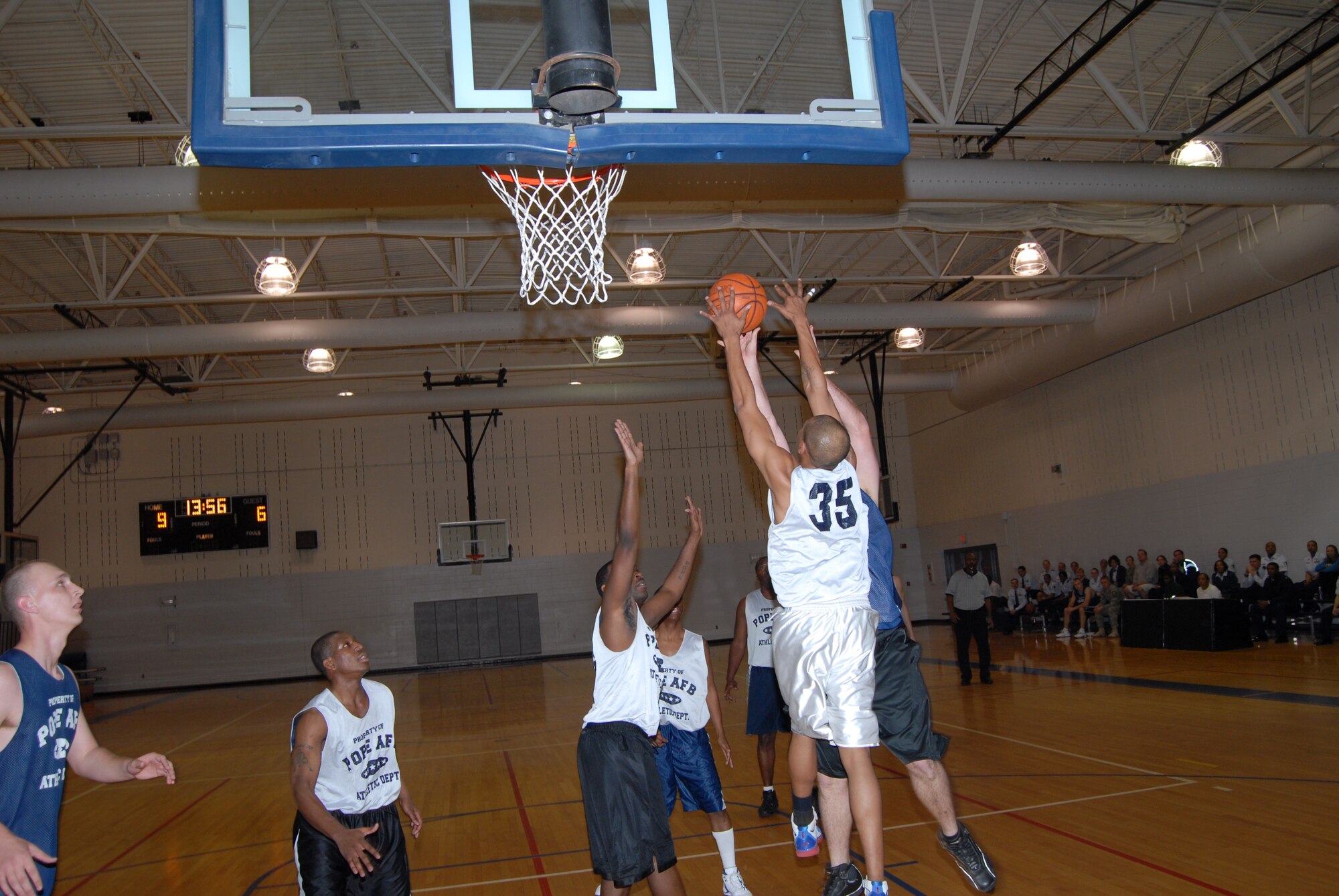 Kenneth Carter, 43rd Logistics Readiness Squadron, rejects the shot of Kasey Crews, 43rd Mission Support during the championship game March 3. (U.S. Air Force Photo by 2nd Lt. Chris Hoyler)