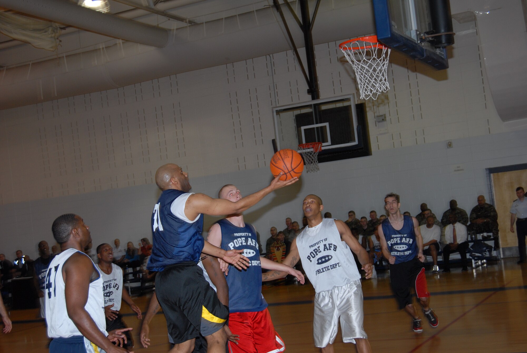 David Bremmer, 43rd Mission Support Squadron, finishes a drive to the basket with a layup during the championship game against 43rd Logistics Readiness Squadron March 3. (U.S. Air Force Photo by 2nd Lt. Chris Hoyler)