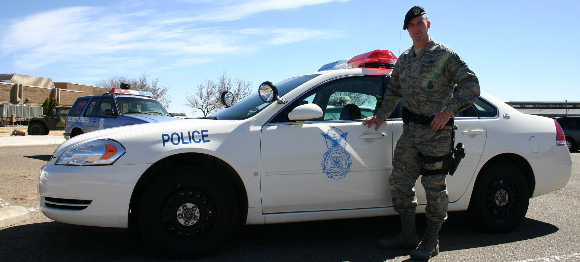 CANNON AIR FORCE BASE, N.M. - Senior Airman Mark Maddonn, 27th Special Operations Security Forces Squadron, stands next to a security forces patrol car. Airman Maddon has been selected to play keyboards with the Air Force's Tops in Blue during their 2008 world tour. (U.S. Air Force photo by Airman 1st Class Elliott Sprehe)