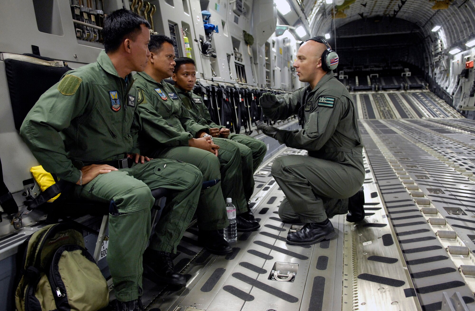 Senior Airman Steven Odland explains a combat offload to members of the Philippine air force on board a C-17 Globemaster III Feb. 27 at Clark Field, Philippines, during Exercise Balikatan '08. Airman Odland is a loadmaster from the Hawaii Air National Guard's 204th Airlift Squadron. (U.S. Air Force photo/Tech. Sgt. Shane A. Cuomo) 