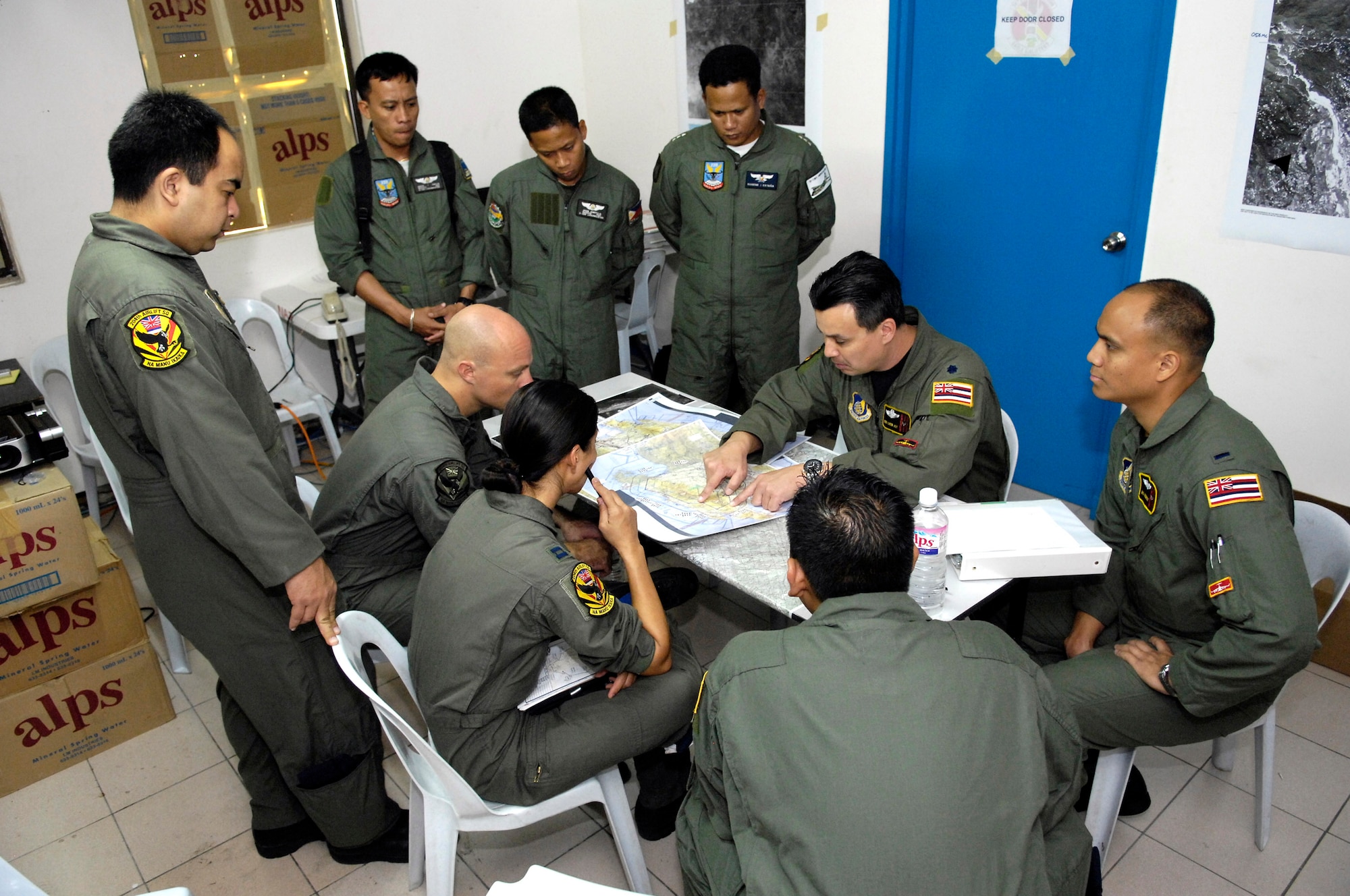 A C-17 Globemaster III aircrew and members from the Philippine air force conduct a pre-mission briefing Feb. 27at Clark Field, Philippines, during Exercise Balikatan '08. Airmen are from the Hawaii Air National Guard's 204th Airlift Squadron and from the 535th Airlift Squadron at Hickam Air Force Base, Hawaii.  Balikatan is an annual joint and bilateral exercise involving U.S. military and Philippines armed forces members. Subject matter experts from the Philippine Civil Defense Agencies and observers from Australia, Indonesia, Malaysia, Brunei, Thailand and Singapore come together to work on humanitarian and disaster relief efforts. (U.S. Air Force photo/Tech. Sgt. Shane A. Cuomo) 