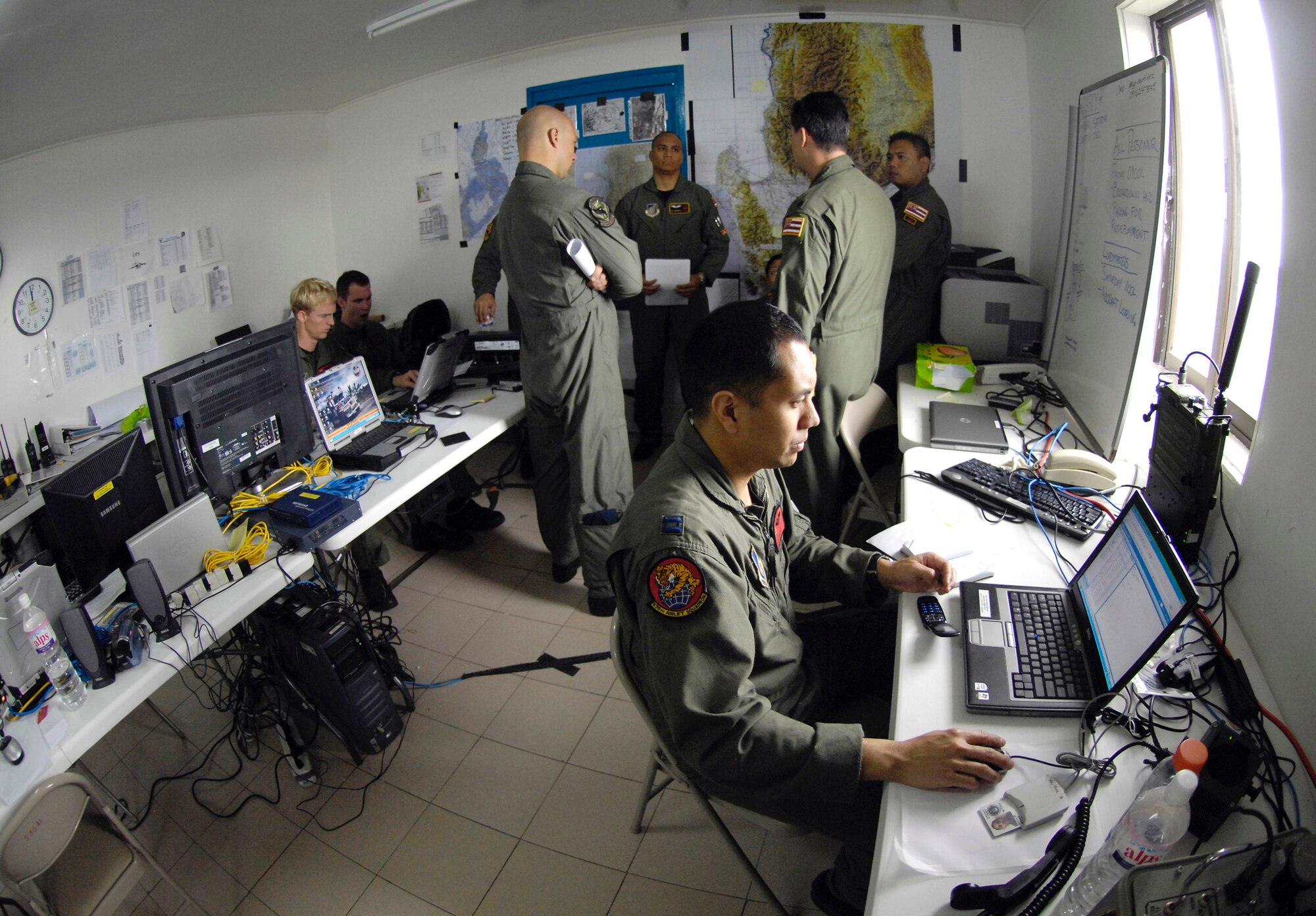 Aircrews conduct pre-mission planning Feb. 27at Clark Field, Philippines, during Exercise Balikatan '08. The Airmen are from the Hawaii Air National Guard's 204th Airlift Squadron and from the 535th Airlift Squadron at Hickam Air Force Base, Hawaii. Balikatan is an annual joint and bilateral exercise involving U.S. military and Philippines armed forces members. Subject matter experts from the Philippine Civil Defense Agencies and observers from Australia, Indonesia, Malaysia, Brunei, Thailand and Singapore come together to work on humanitarian and disaster relief efforts. (U.S. Air Force photo/Tech. Sgt. Shane A. Cuomo) 

