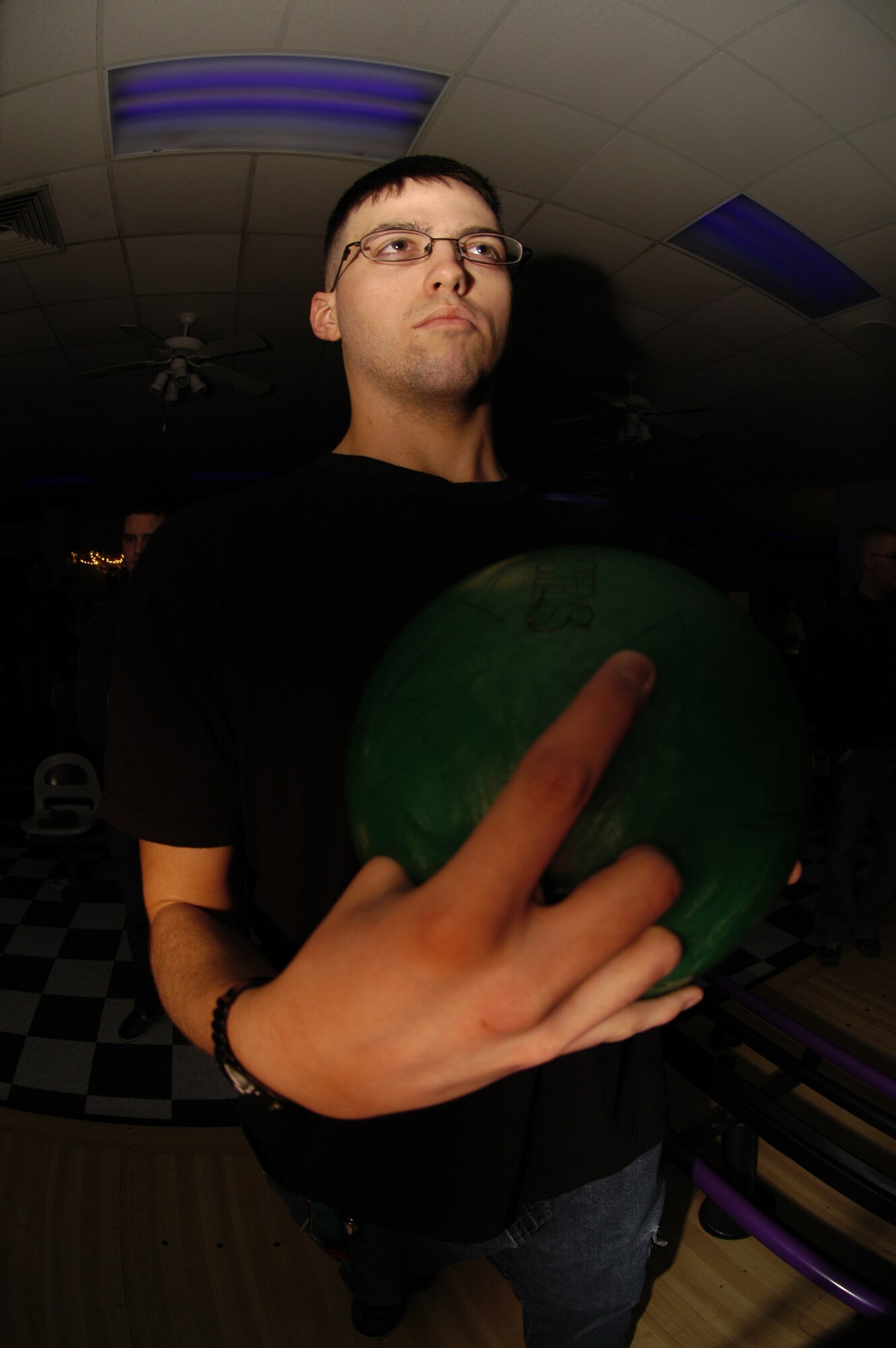 Airman 1st Class Ivan Sawyer, 736th Aircraft Maintenance Squadron, focuses on getting a strike during Thunder Alley bowling at the Eagle Lanes Bowling Center March 1. Each Saturday evening from 8 – 11 p.m. the Bowling Center offers family-oriented entertainment with glow-in-the-dark bowling, revolving lights and music. (U.S. Air Force photo/Airman 1st Class Shen-Chia Chu) 