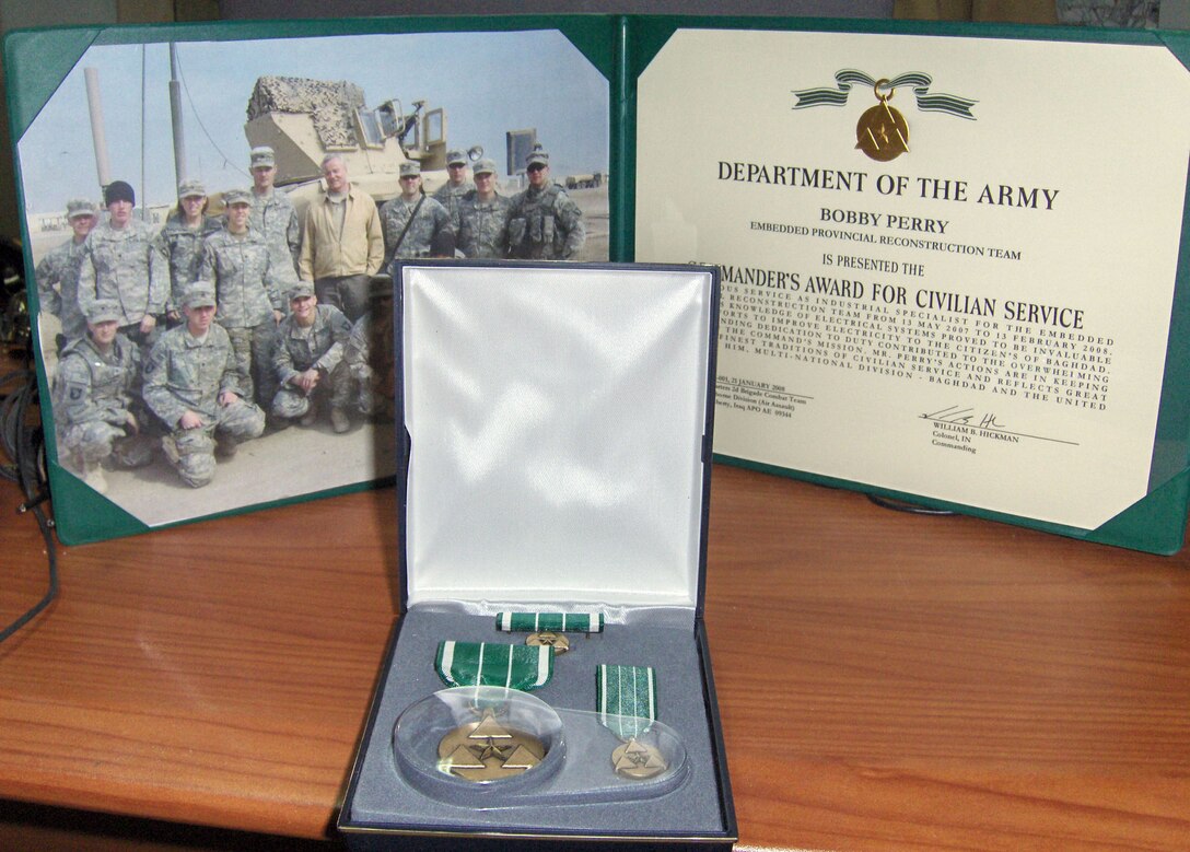 Bob Perry, a 416th Flight Test Squadron project manager, received the Commander's Award for Civilian Service for his contributions as the senior industrial advisor of the embedded provincial reconstruction team with the 2nd Brigade Combat Team, 1st Infantry Division in Iraq. Mr. Perry was deployed from May to February. (Courtesy photo)