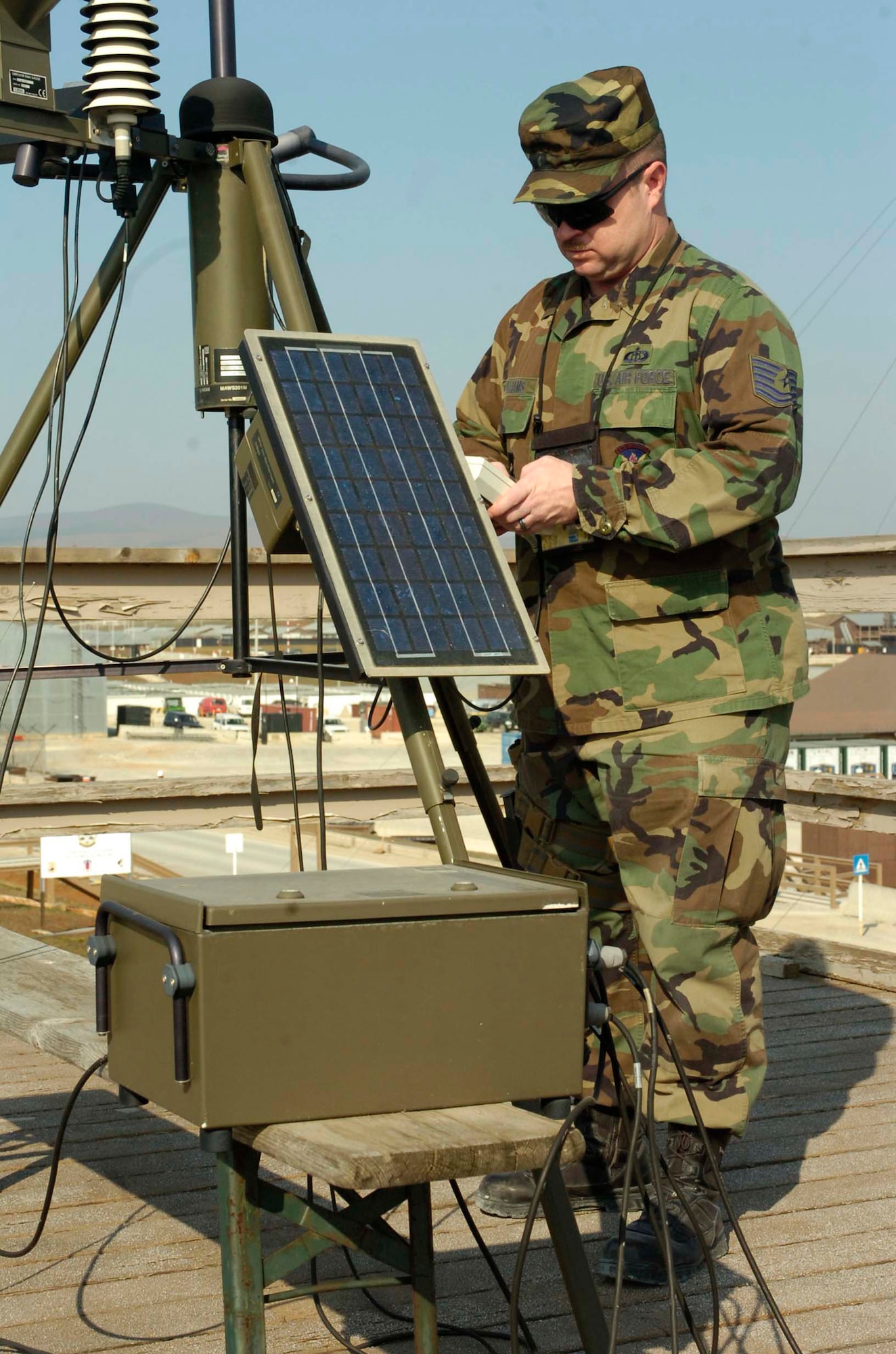 Tech. Sgt. Scott Williams works with sensory equipment on top of a weather tower Feb. 29 at Camp Bondsteel, Kosovo. Sergeant Williams, a combat weatherman, and three Air National Guardsmen provide 24/7 weather forecasting to rotary-winged aircrews and 1,400 Soldiers deployed to Camp Bondsteel. (U.S. Army photo/Spc. Tara Moseman) 
