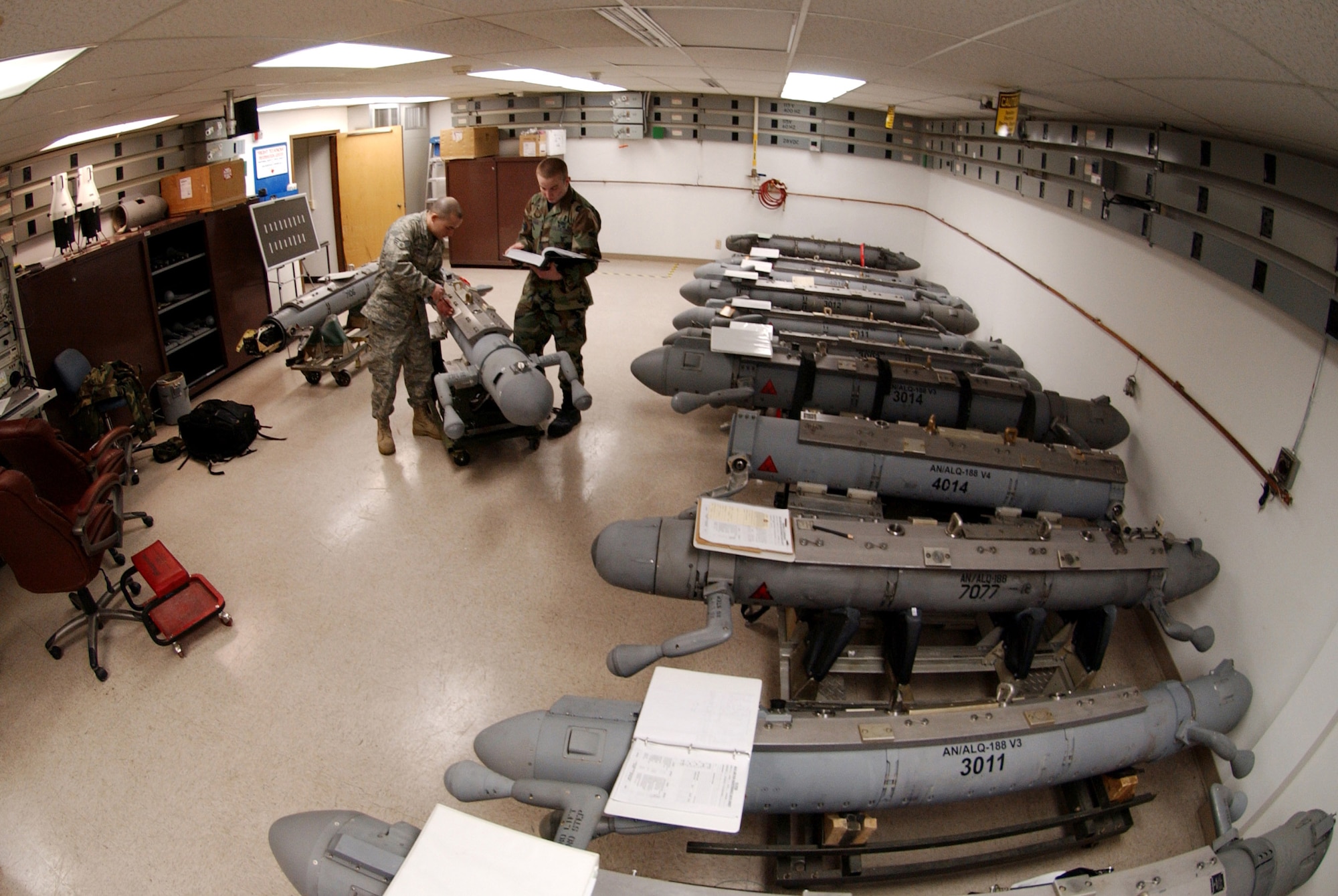 Senior Airman Frank Canfield assists Airman 1st Class Timothy Ogburn in replacing safety wire on an electronic attack pod Feb. 27 in the Avionics Flight at Eielson Air Force Base, Alaska. The pods, maintained by the flight against Alaska's harsh arctic winters, provide an offensive electronic attack that degrades an enemy aircraft's radar. Airman Canfield is an avionics sensors journeyman and Airman Ogburn is an electronic warfare journeyman. Both are assigned to the 354th Maintenance Squadron. (U.S. Air Force photo/Airman 1st Class Christopher Griffin) 