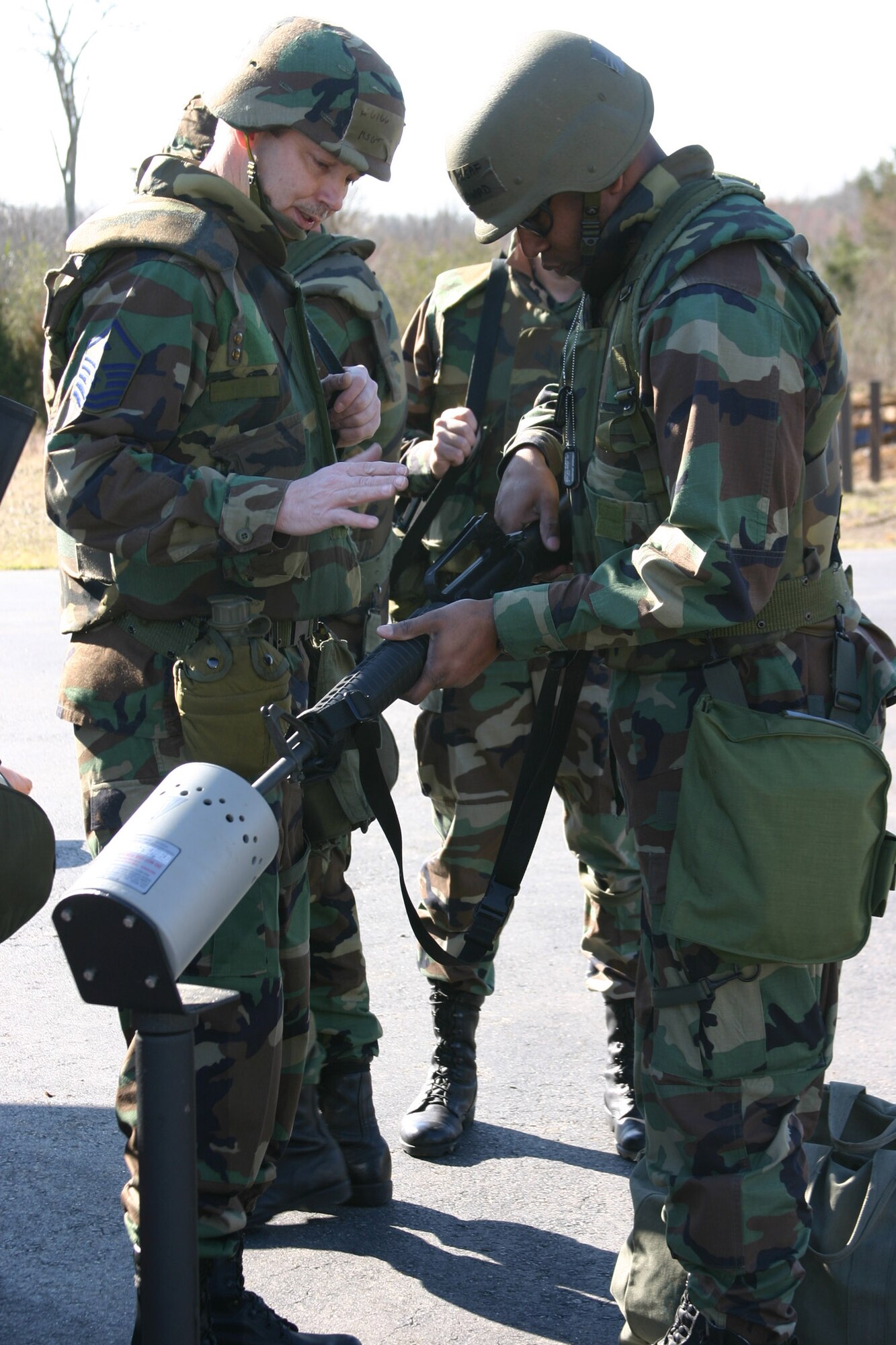 Master Sgt. Virgil D. Healey shows Capt. Claude Howard how to properly clear his M-16 rifle before entering the exercise area for a briefing. (U.S. Air Force photo by Airman 1st Class Kayla K. Edwards)