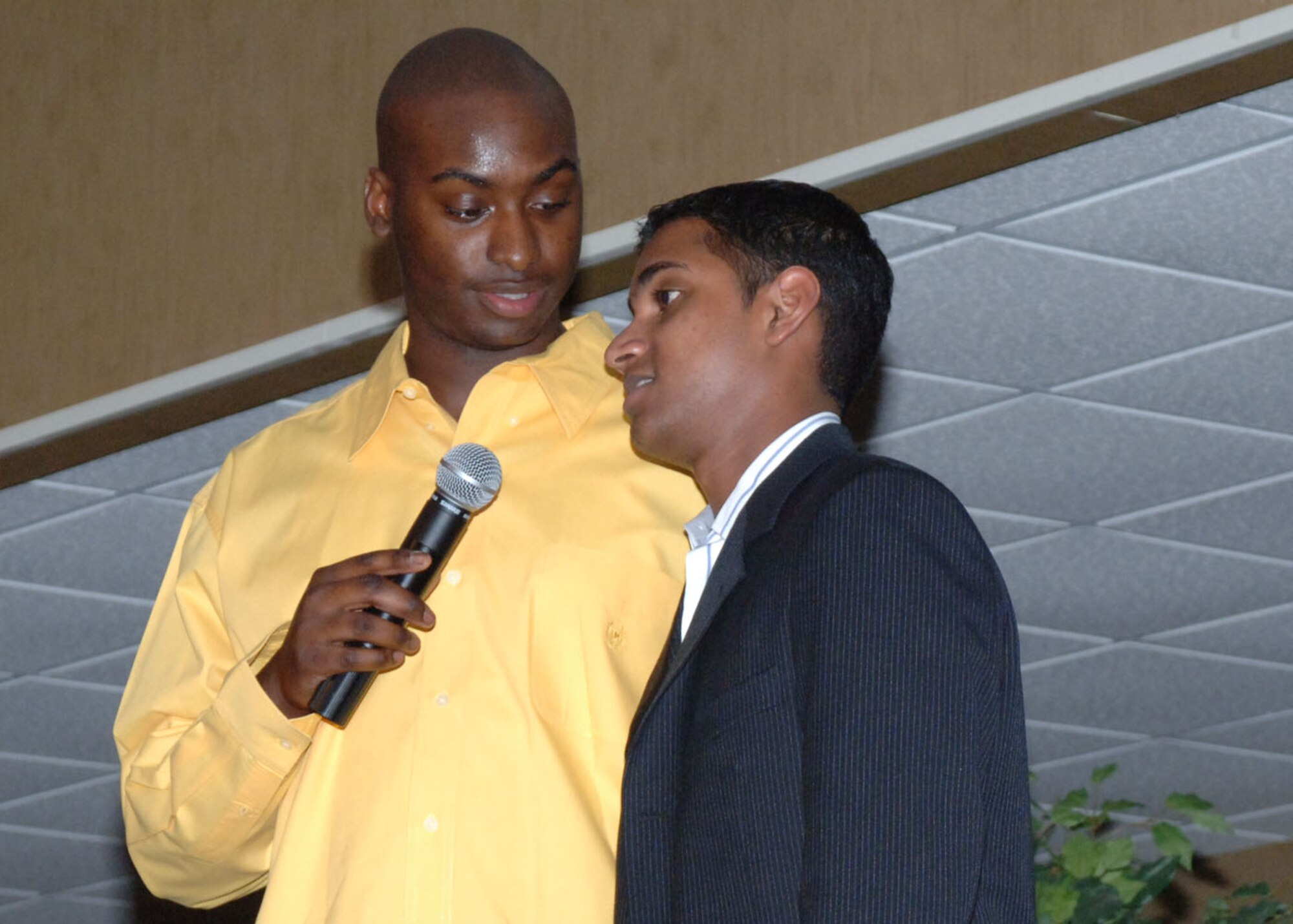 Staff Sgt. Anthony Vick, 14th Security Forces Squadron and guest emcee, talks with Airman 1st Class Siddharth Sunny, 14th Force Support Squadron, before Airman Sunny's performance at the "Columbus Idol" event Friday night. The BLAZE 56 Council hosted the event, which featured seven contestants. The competition was similar to the popular "American Idol" competition. (U.S. Air Force photo by Airman 1st Class Danielle Hill)