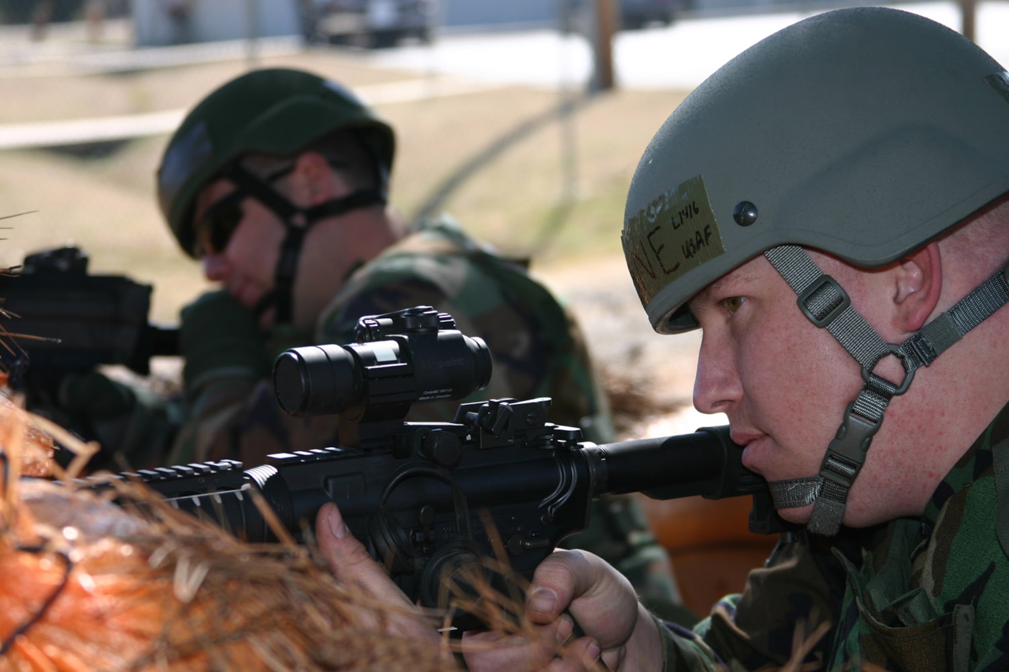 189th Security Forces Squadron Senior Airman Brandon Lane and Staff Sgt. William Franklin protect their defensive fighting positions with M-4 carbine rifles. (U.S. Air Force photo by Airman 1st Class Kayla K. Edwards)