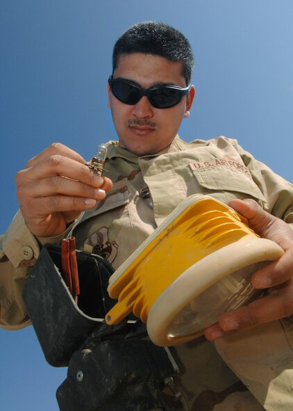 Airman Nicholas Wengerd changes out an approach light Feb. 28 at Balad Air Base, Iraq. The approach lights help to illuminate the runway during nighttime landing operations. Airman Wengerd, a 332nd Expeditionary Civil Engineer Squadron electrician, is deployed from Ellsworth Air Force Base, S.D. (U.S. Air Force photo/Senior Airman Julianne Showalter) 