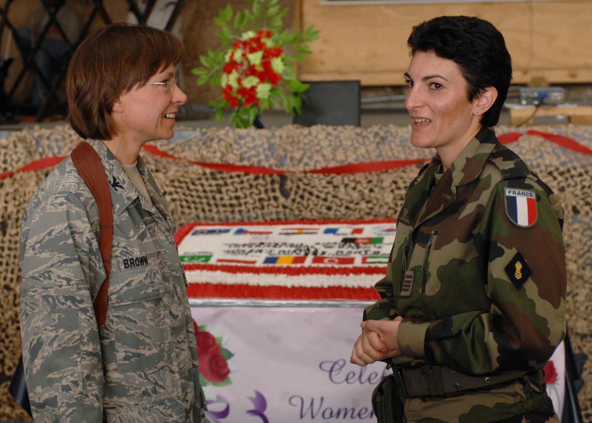 BAGRAM AIR BASE, Afghanistan -  Col. Rebecca Brown, 455th Expeditionary Medical Operations Squadron commander, and Maj. Angelique Esperance, contracting and legal officer for the French Forces, discuss the day's events at the International Women's Day held here March 3. Hundreds turned out to the festivities to celebrate the world's women and acknowledge women's contributions to peace and security. (U.S. Air Force photo by Master Sgt. Demetrius Lester) 