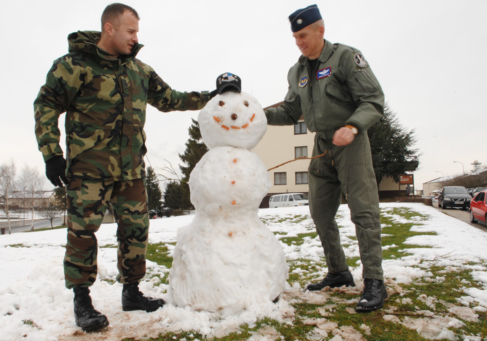 SPANGDAHLEM AIR BASE, Germany -- Lt. Col. Mark Hedman and Master Sgt. Gary Kimball, 52nd Fighter Wing Inspector General office, take a few moments at lunchtime to build a snowman outside their office March 4, 2008. Two inches of snow fell in the area today and, while not exceptional for this time of year, it was a surprise for most base residents. (U.S. Air Force photo/Senior Airman Logan Tuttle)
