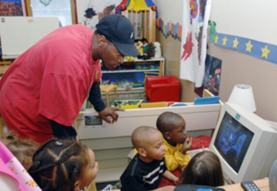 Mr. Tyrone Dukes, 39th Services Squadron Child Development Center lead room technician, or “preschool head teacher”, observes pre-kindergarten students playing a computer game Feb. 13 at the CDC. Allowing children to interact and play on a computer is an example of a technique outlined in the Creative Expressions through Cognitive Development program. (U.S. Air Force photo by Staff Sgt. Jeff Nevison)