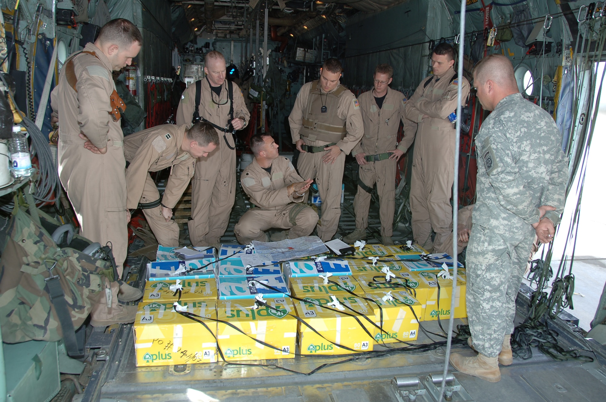 ALI BASE, Iraq - Lieutenant Col. Eric Mayheu, a C-130 pilot from the 737th Expeditionary Airlift Squadron, gives a pre-mission brief to aircrew members and walks-thru the pending leaflet air drop sequence of events recently. The leaflets were dropped over southern Iraq in Support of Operation Iraqi Freedom. (U.S. Air Force photo/Senior Master Sgt. Miguel Espinoza)