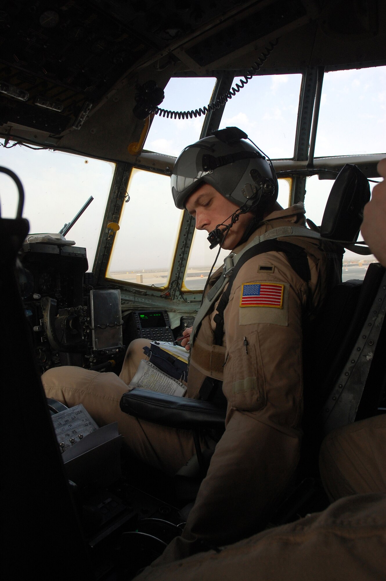 SOUTHWEST ASIA -- First Lt. Brock Burkhardt, a co-pilot with the 737th Expeditionary Airlift Squadron goes through his preflight checklist for a C-130 Hercules at a Southwest Asia air base recently. The mission is part of leaflet air drop mission supporting the Australians from Overwatch Battle Group [West]-4 in southern Iraq. Lieutenant Burkhardt is deployed from Ramstein Air Base, Germany, in support of Operations Enduring and Iraqi Freedom. (U.S. Air Force photo/Tech. Sgt. Michael O’Connor)