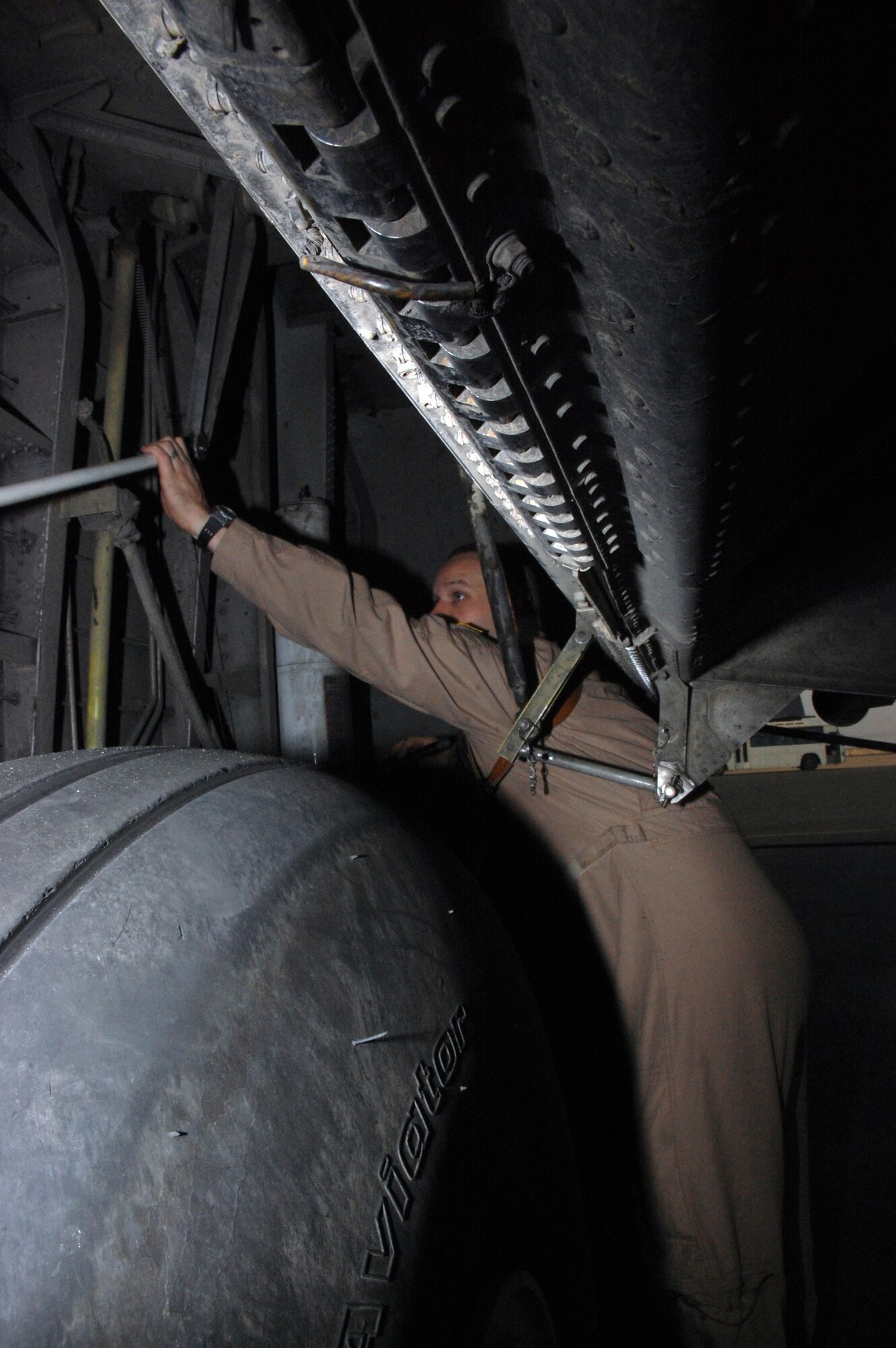 SOUTHWEST ASIA -- Technical Sgt. Daniel Hockenberry, flight engineer with the 737th Expeditionary Airlift Squadron, checks the landing gear of a C-130 Hercules as during a recent preflight inspection. The leaflet air drop mission is for the Australian military from Overwatch Battle Group [West]-4 in southern Iraq. Sergeant Hockenberry is deployed from Ramstein Air Base, Germany, in support of Operations Enduring and Iraqi Freedom. (U.S. Air Force photo/Tech. Sgt. Michael O’Connor)