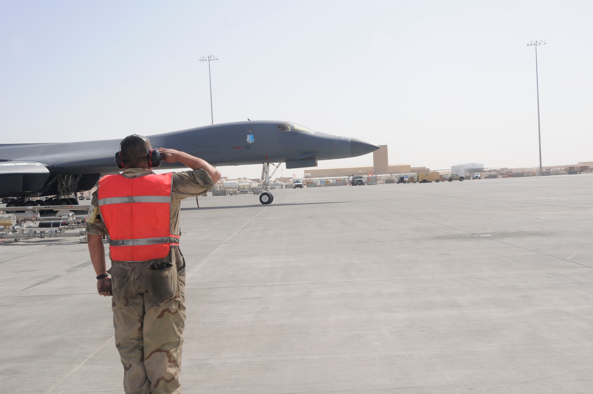 Airman 1st Class Kenzi Klingenberg marshals a B-1 Lancer on the flightline here Feb. 27.  Airman Klingenberg is a part of the 37th Aircraft Maintenance Unit. (U.S. Air Force photo/ Senior Airman Domonique Simmons)