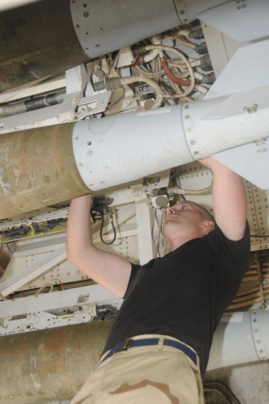 Senior Airman Isaac Loren, a 37th Aircraft Maintenance Unit load team member, uploads GBU-38s here Feb. 27. (U.S. Air Force photo/Senior Airman Domonique Simmons)