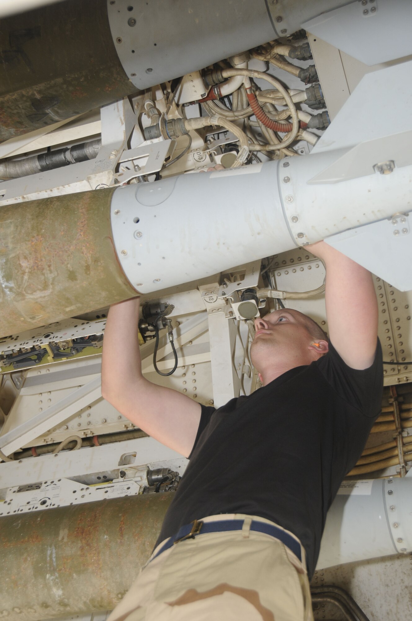 Senior Airman Isaac Loren, a 37th Aircraft Maintenance Unit load team member, uploads GBU-38s here Feb. 27. (U.S. Air Force photo/Senior Airman Domonique Simmons)