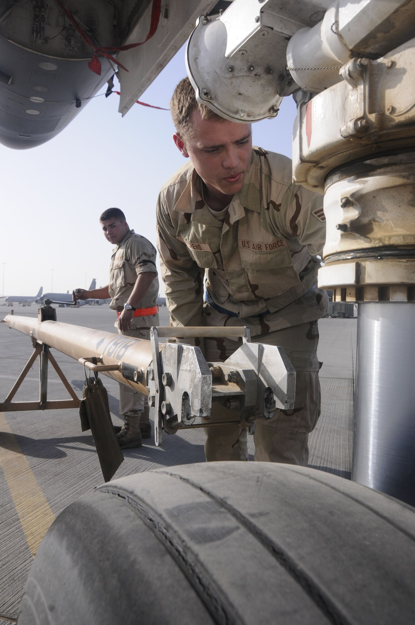 Senior Airman Christopher Hutchens prepares a B-1 Lancer to be towed and refueled Feb. 27. Airman Hutchens deployed to the 37th Aircraft Maintenance Unit. (U.S. Air Force photo/Senior Airman Domonique Simmons)