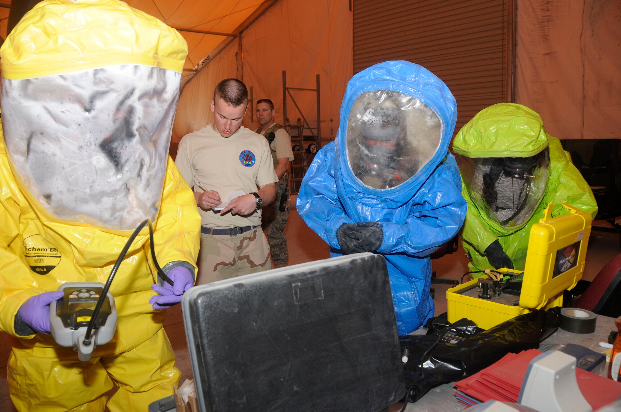 (Left to right) Senior Airman Jonathan Sawmiller, Staff Sgt. Chance Miller, and Staff Sgt. Miranda Converse; take samples of white powder from a simulated bio hazard site Feb. 29. The team of two emergency management members and one bioenvironmental engineering technician demonstrated a combined effort between different career fields during a 379th Expeditionary Civil Engineer Squadron training exercise here. (U.S. Air Force photo/ Senior Airman Domonique Simmons)