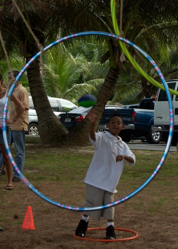 ANDERSEN AFB, Guam - Children throw a football throw hula-hoops to test their accuracy during the 36th Services Squadron's customer appreciation picnic Feb. 29 at Tarague Beach. (U.S. Air force photo by Airman First Class Zachary Hunter)(RELEASED)
