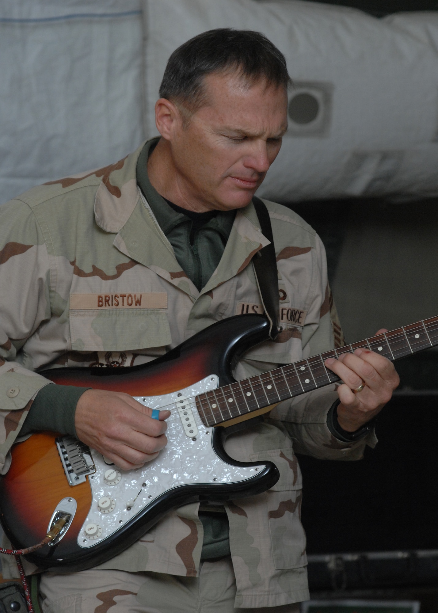 BAGRAM AIR BASE, Afghanistan - Senior Master Sgt. James Bristow, 'Live Round' guitarist and vocalist, brings his guitar to life during the band's performance here Feb. 24.  'Live Round' is the U.S. Air Forces Central band that performs for servicemen and women and local communities throughout Southwest Asia. (U.S. Air Force photo by Master Sgt. Demetrius Lester)