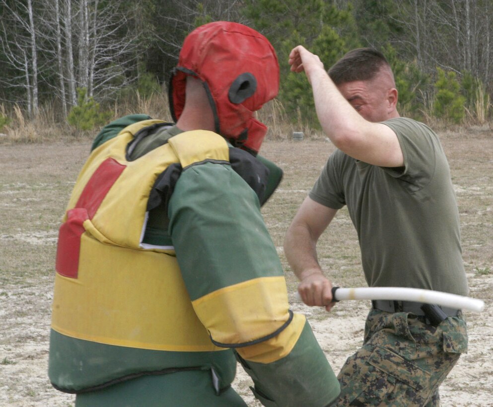 Staff Sgt. Brandon Jacobs, left, Platoon 3245, Co. L, asks Recruit Greg Person, Platoon 3246, about the proper techniques of climbing the 30-foot rope at the end of the course. Lance Cpl. Charlie Chavez/Chevron