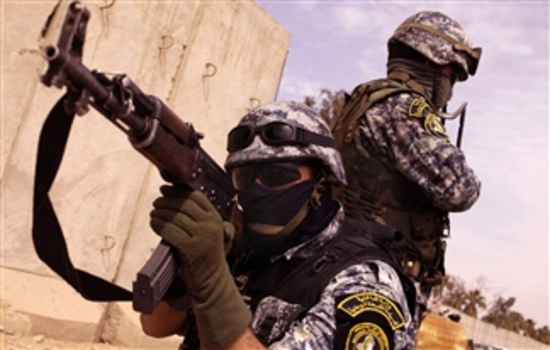 Iraqi National Police wait while U.S. Army soldiers  pay members of the U.S. contracted security group Ibnaa al-Iraq (Sons of Iraq) at Al Qanat Joint Security Station, Baghdad, Iraq, Feb. 29, 2008. The U.S. soldiers are assigned to the 10th Mountain Division's 89th Cavalry Regiment, 4th Brigade.