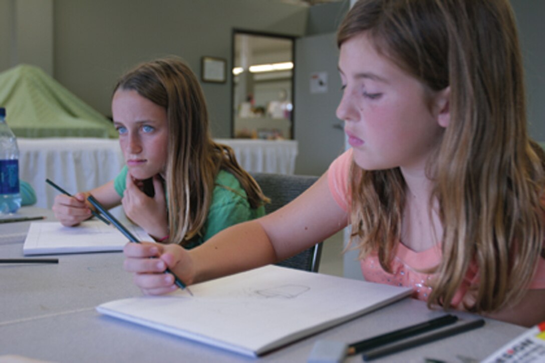 Samantha Smith, left, and Jordyn Prouty, two students participating in the Camp Pendleton Arts & Crafts Hobby Workshop, attend their first art session, March 4.