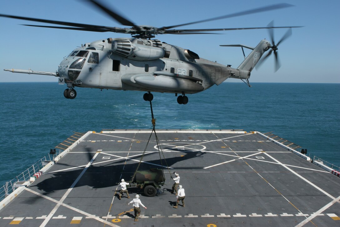 OFF THE COAST OF NORTH CAROLINA ABOARD USS SAN ANTONIO (March 5, 2008) – Combat cargo Marines from the 26th Marine Expeditionary Unit's Logistics Combat Element, Combat Logistics Battalion-26, steady an external load for a CH-53E Super Stallion helicopter from the 26th MEU's Aviation Combat Element, Marine Medium Helicopter Squadron-264 (Rein), March 5, 2008, aboard the USS San Antonio during the ship's Operational Evaluation.  (Official USMC photo by Cpl. Aaron J. Rock) (Released)