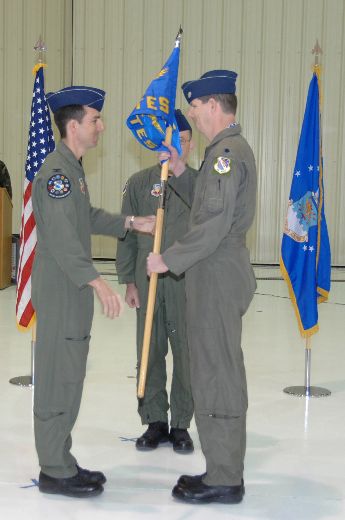 CREECH AIR FORCE BASE, Nev. -- Col. Brian O' Rear, 53rd Test and Evaluation Group deputy commander, hands off the guideon to Lt. Col. Ty Moyers, 556th Test and Evaluation Squadron commander, during a squadron activation ceremony here March 5. (U.S. Air Force photo/Staff Sgt. Scottie McCord)
