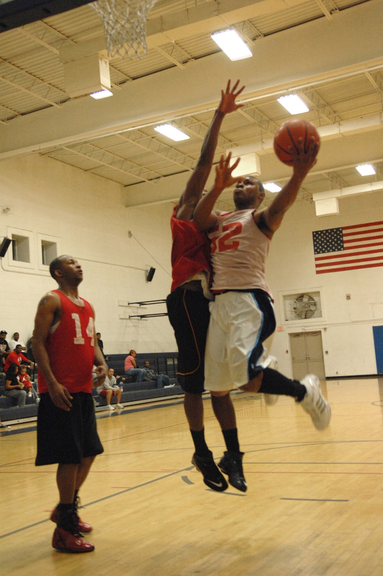 NELLIS AIR FORCE BASE, Nev.—Senior Airman Tramaine West (right), 57th Equipment Maintenance Squadron Ammunitions Flight, goes for a lay-up during the Nellis 2008 intramural basketball championship game, Feb. 27. The 57th Equipment Maintenance Squadron Munitions Flight took home this years championship trophy, defeating 99th LRS 73-63. (U.S. Air Force photo by Senior Airman Larry E. Reid Jr.)