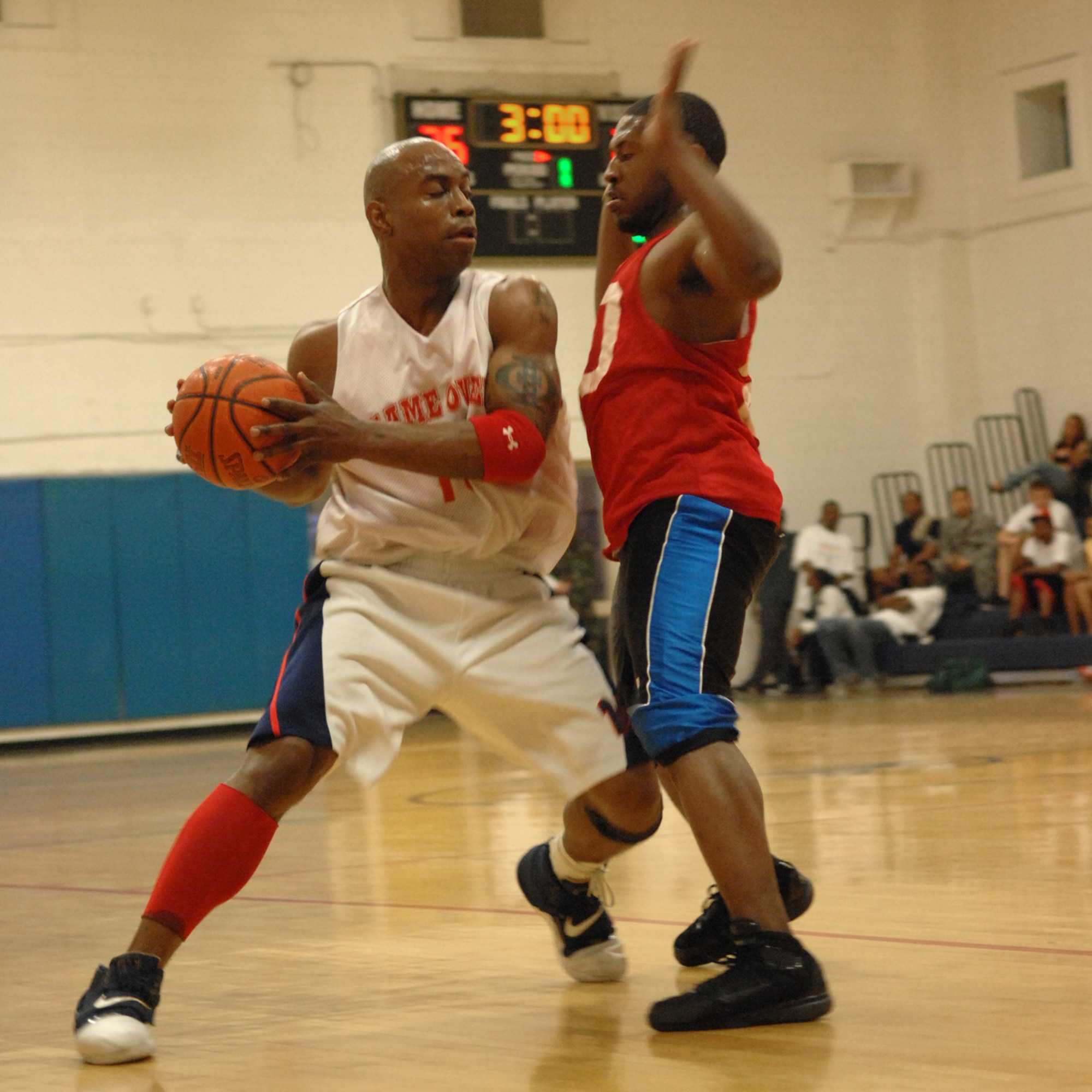 NELLIS AIR FORCE BASE, Nev.—Staff Sgt. Gregory Wilson (left), 57th Equipment Maintenance Squadron Munitions Flight, eludes a defender during the Nellis 2008 intramural basketball championship game, Feb. 27. The 57th Equipment Maintenance Squadron Munitions Flight took home this years championship trophy, defeating 99th LRS 73-63. (U.S. Air Force photo by Senior Airman Larry E. Reid Jr.)