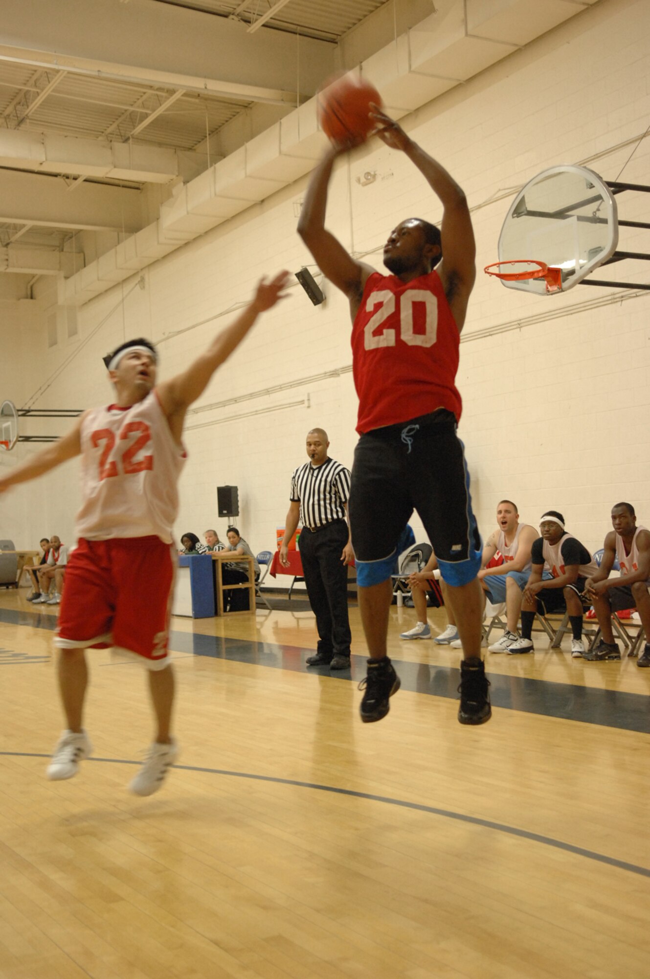 NELLIS AIR FORCE BASE, Nev.—Senior Airman Ryan Pratcher (right), 99th Logistics Readiness Squadron, pulls up for a jump shot during the Nellis 2008 intramural basketball championship game, Feb. 27. The 57th Equipment Maintenance Squadron Munitions Flight took home this year’s championship trophy, defeating 99th LRS 73-63. (U.S. Air Force photo by Senior Airman Larry E. Reid Jr.)