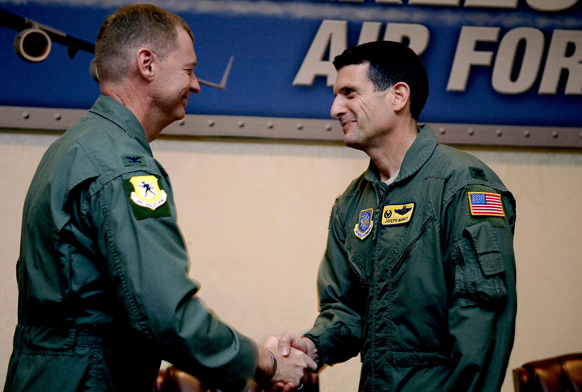 Col. John ?Red? Millander congratulates Col. Joseph Mancy after the 437th Operation Group?s change of command at the Charleston Club Feb. 29. Colonel Mancy assumed command of the group and Colonel Millander is the 437th Airlift Wing commander. (U.S. Air Force photo/Senior Airman Nicholas Pilch)  