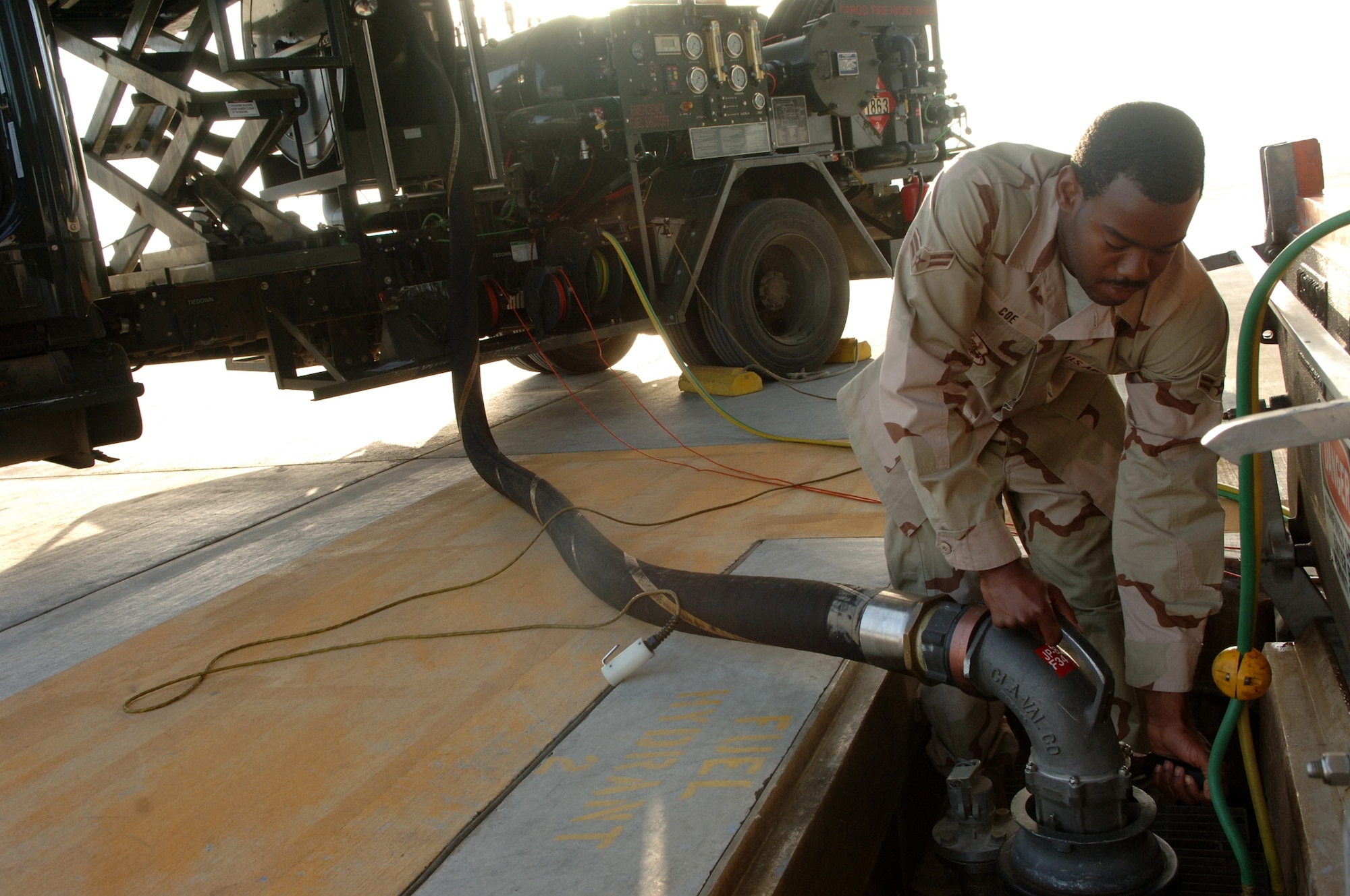 Airman 1st Class Zechariah Coe, fuels distribution operator, 380th Expeditionary Logistics Readiness Squadron connects a fuel hose from an R12 Hydrant Servicing Vehicle to an underground fuel storage tank in preparation to break the Air Force record for the largest amount of fuel pumped in a month, Southwest Asia, Monday, February 25, 2008. Airman Coe took on every refueling opportunity he could to pump the more than 3,573,989 gallons of fuel that was required to break the previous record.