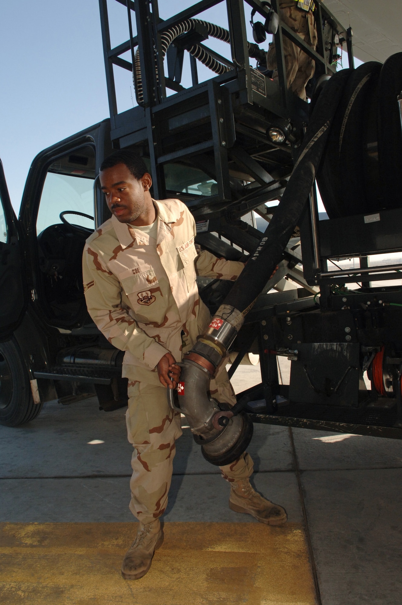 Airman 1st Class Zechariah Coe, fuels distribution operator, 380th Expeditionary Logistics Readiness Squadron extends a fuel hose from an R12 Hydrant Servicing Vehicle to an underground fuel storage tank in preparation to break the Air Force record for the largest amount of fuel pumped in a month, Southwest Asia, Monday, February 25, 2008. Airman Coe took on every refueling opportunity he could to pump the more than 3,573,989 gallons of fuel that was required to break the previous record.