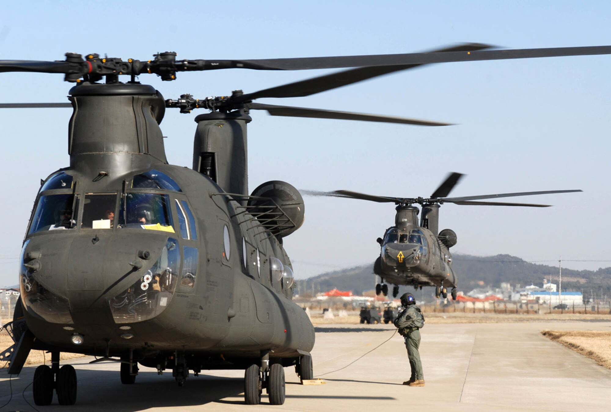 Two CH-47 Chinook helicopter's land March 1at Kunsan Air Base, South Korea. The Chinook's arrived from Camp Humphrey's, Bravo Company 4-2, as part of the Key Resolve/Foal Eagle Exercise, enhancing combat readiness and joint interoperability. (U.S. Air Force photo/Senior Airman Steven R. Doty) 
