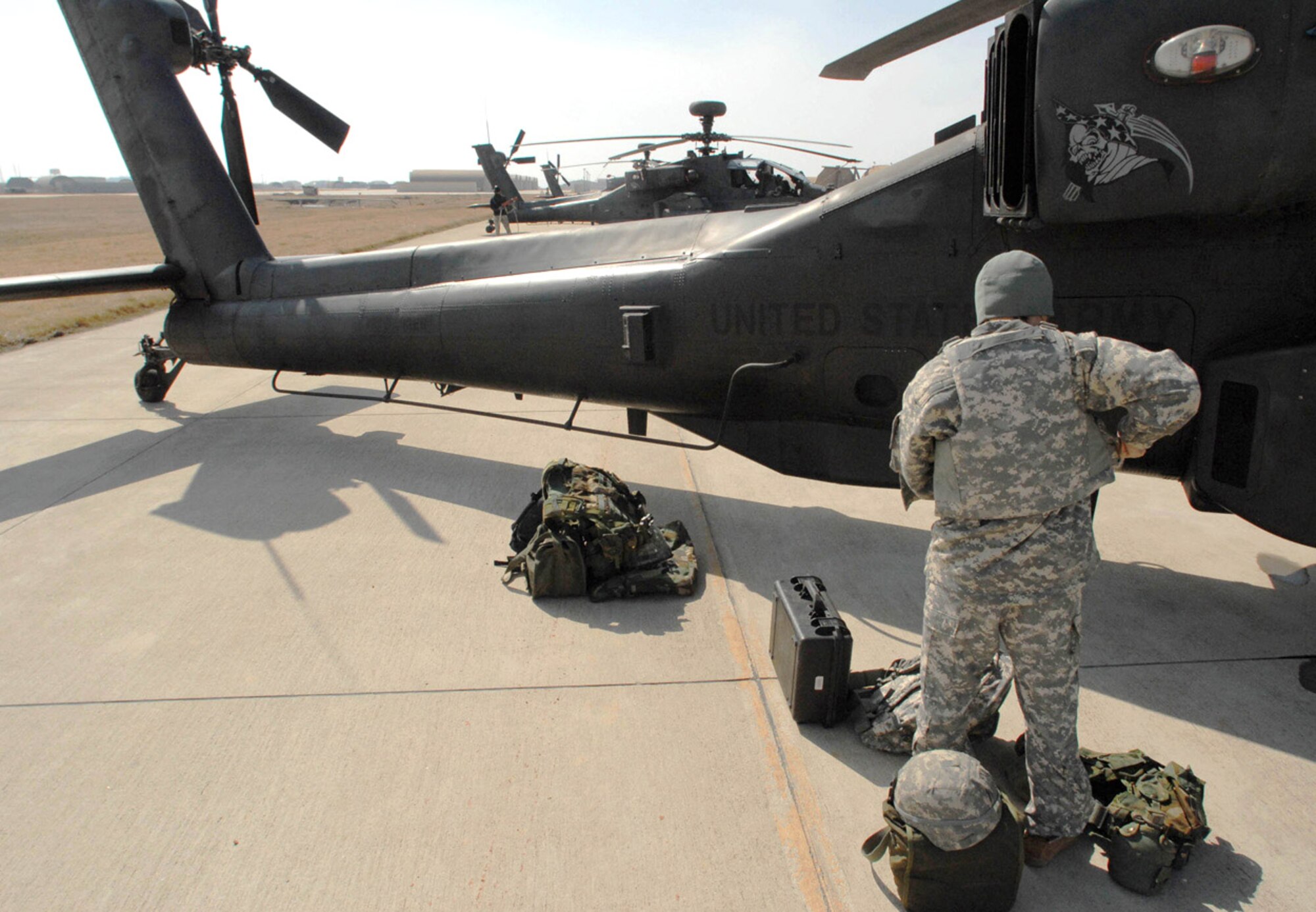 Pilot Capt. Ashley Lee unloads after touching down in an AH-64 Apache helicopter March 1 at Kunsan Air Base, South Korea. The Apache's arrived from Camp Humphrey's, Bravo Company 4-2, as part of the Key Resolve/Foal Eagle Exercise, enhancing combat readiness and joint interoperability. (U.S. Air Force photo/Senior Airman Steven R. Doty) 