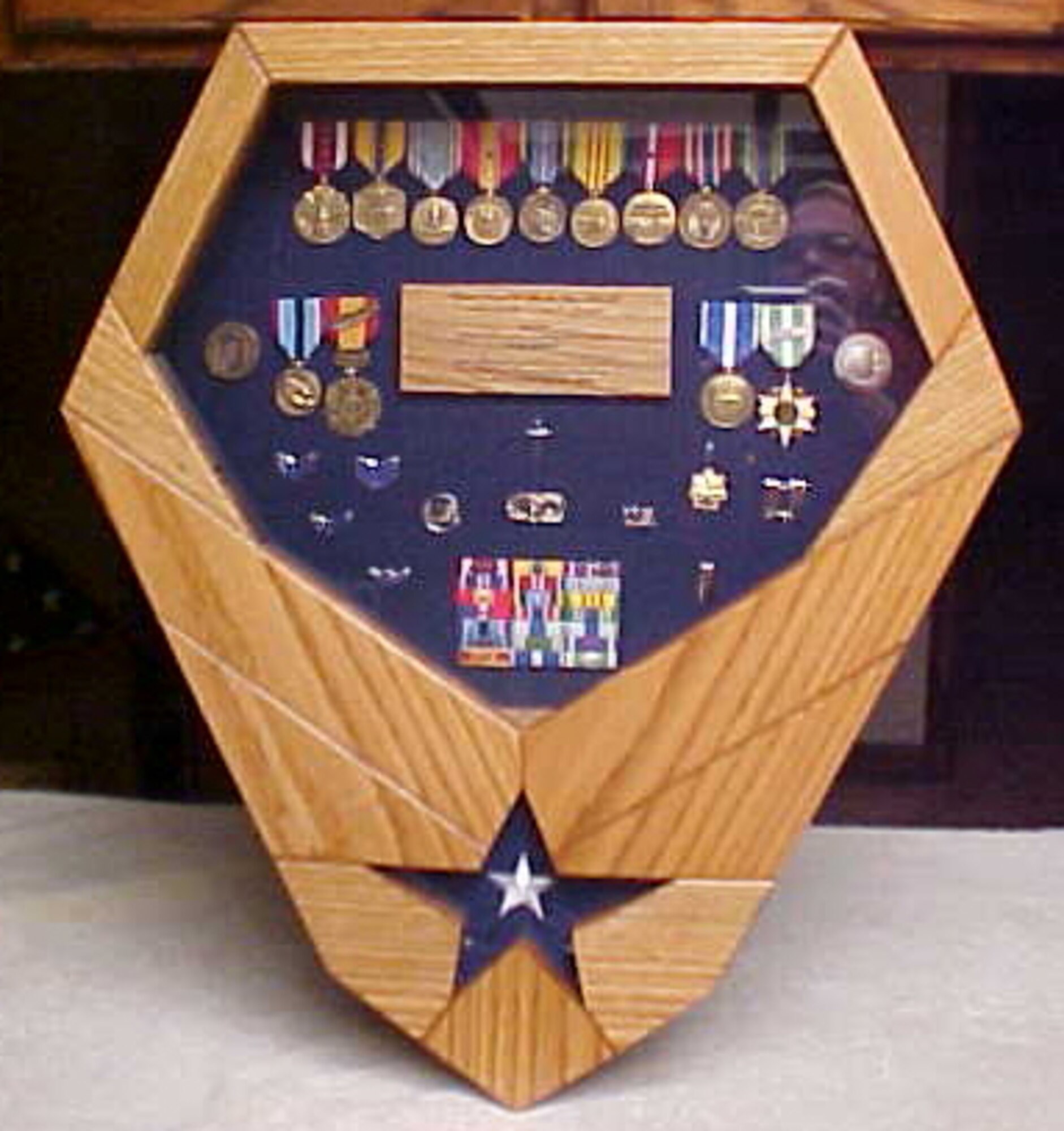 This display, made in the shape of the Air Force symbol, holds uniform rank, awards and decorations. (Photo courtesy of retired Command Chief Master Sgt. Steven Long)


