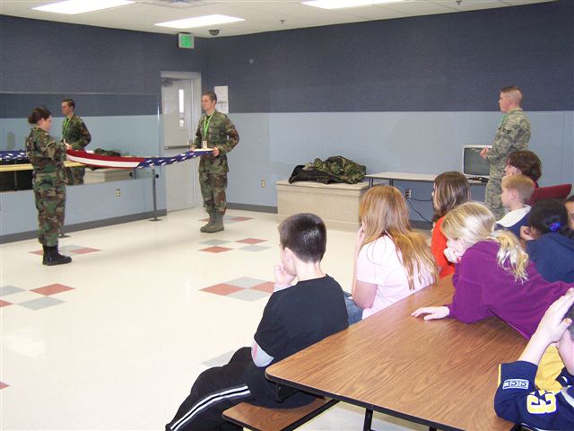 WHITEMAN AIR FORCE BASE, Mo. - Members of the Base Honor Guard conduct a flag folding program for youth during a recreation program at the youth center.  The youth center is open 6:30am-6:00pm Monday thru Wednesday, 6:30am-8:00pm Thursday, 6:30am-10:30pm Friday and Saturday is open for special programs. (Photo printed with permission of Connie Morton)