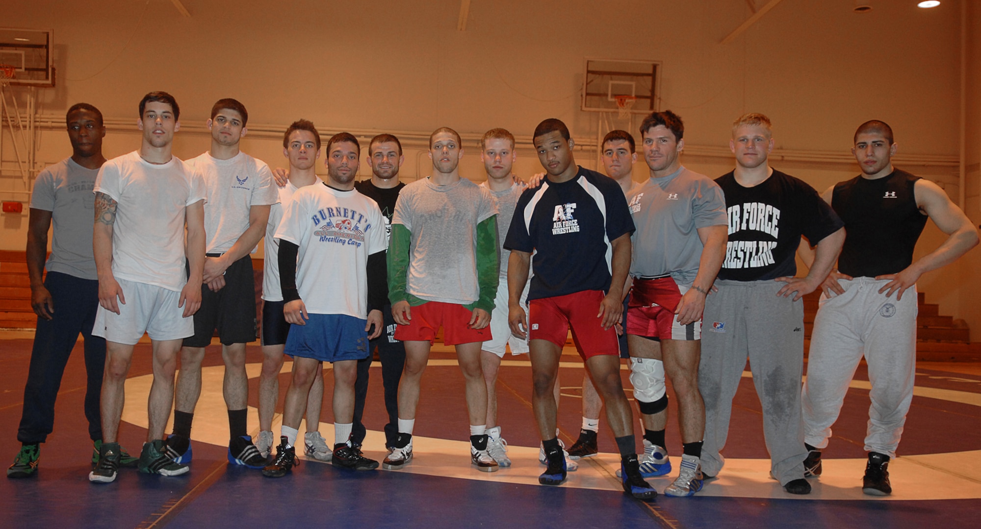 MOUNTAIN HOME AIR FORCE BASE, Idaho -- Members of the All Air Force Wrestling team pose for a picture at the fitness center March 5. Beginning Feb. 13, almost two dozen potential candidates for the All Air Force Wrestling Team began tryouts for the 2008 wrestling season. After more than 120 candidates sent applications to Richard Estrella, the Air Force wrestling coach for 21 years, he chose the 13 most-talented athletes to join the team. (U.S. Air Force photo/Airman 1st Class Stephany Miller)